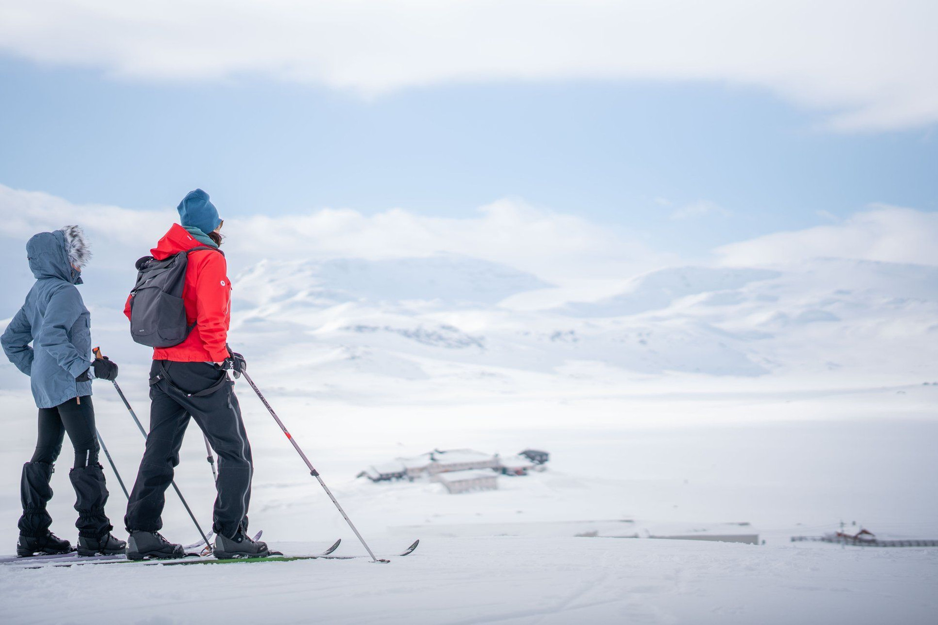 Skieurs de fond surplombant un refuge sur le Hardangervidda - Norvège