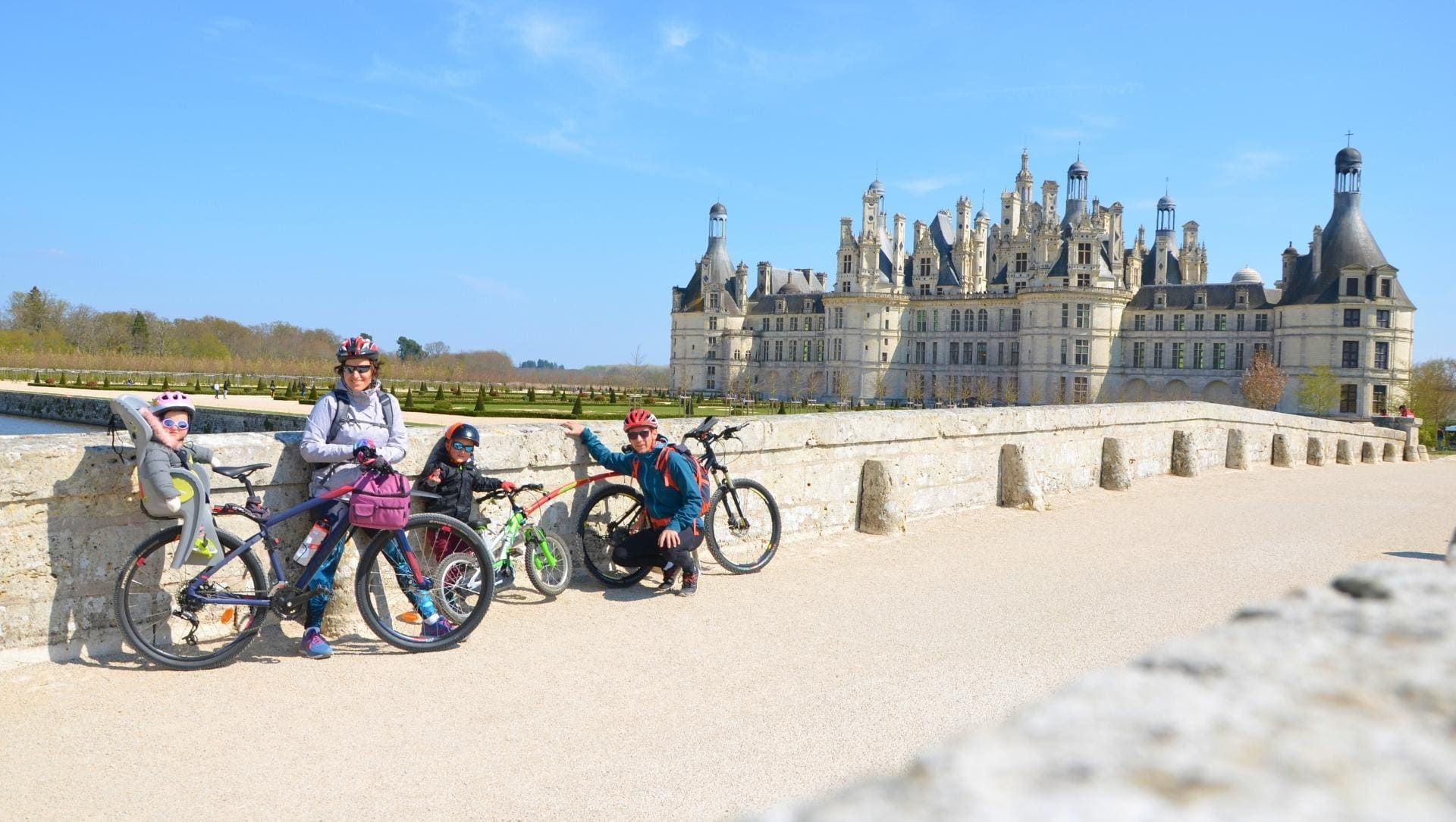 Famille à vélo devant le château de Chambord - Val de Loire - France