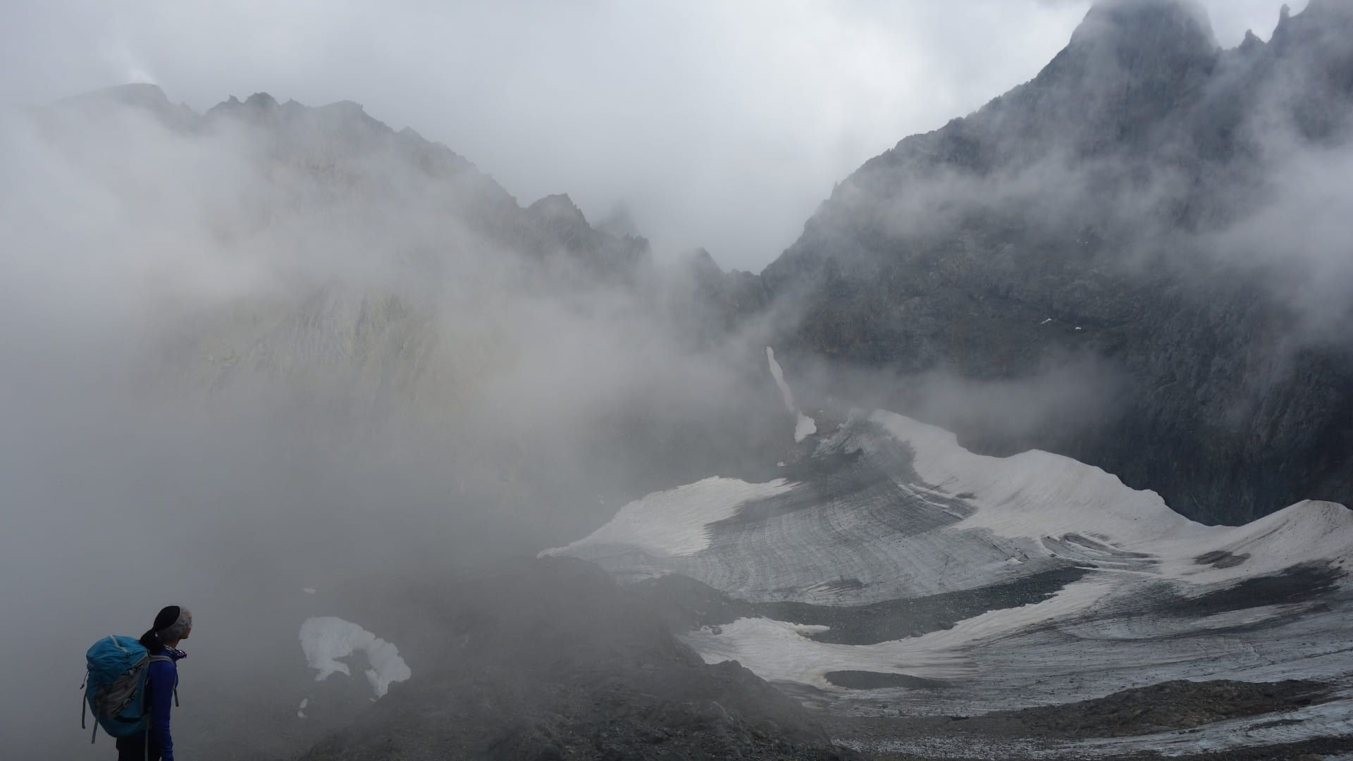 © Adrien Ozanon Randonneur face au glacier de Freydane dans la brume - Belledonne - France