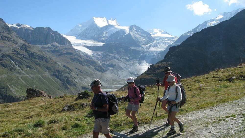 Hikers facing a glacier - Valais Alps - Switzerland