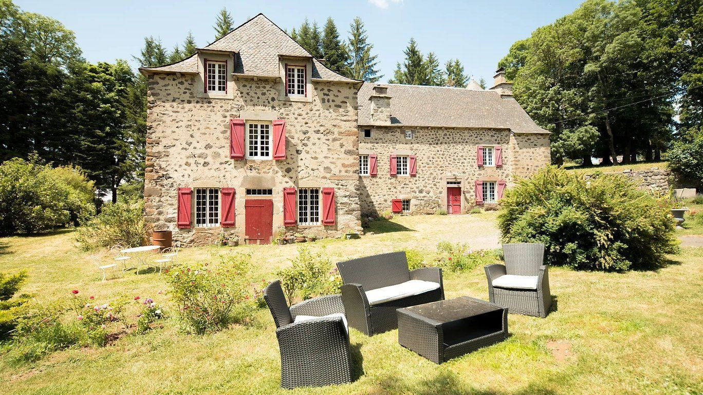 Ferme en pierre aux volets rouges et son jardin - La Ferme des Prades - Auvergne, France