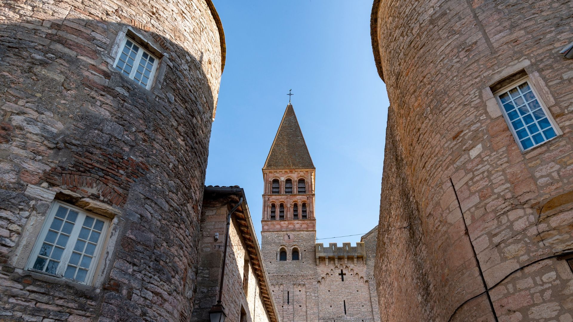 The tower of Saint-Philibert Abbey among the houses of Tournus